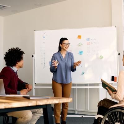 Women presenting in room with white board