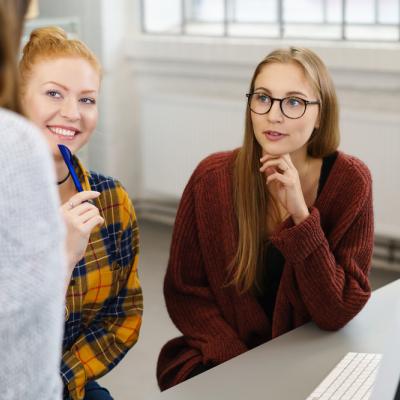 Two students looking at person