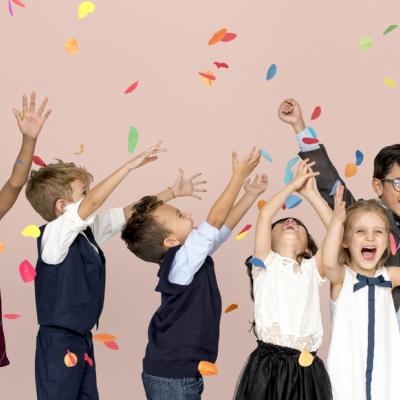kids with arms in air and confetti